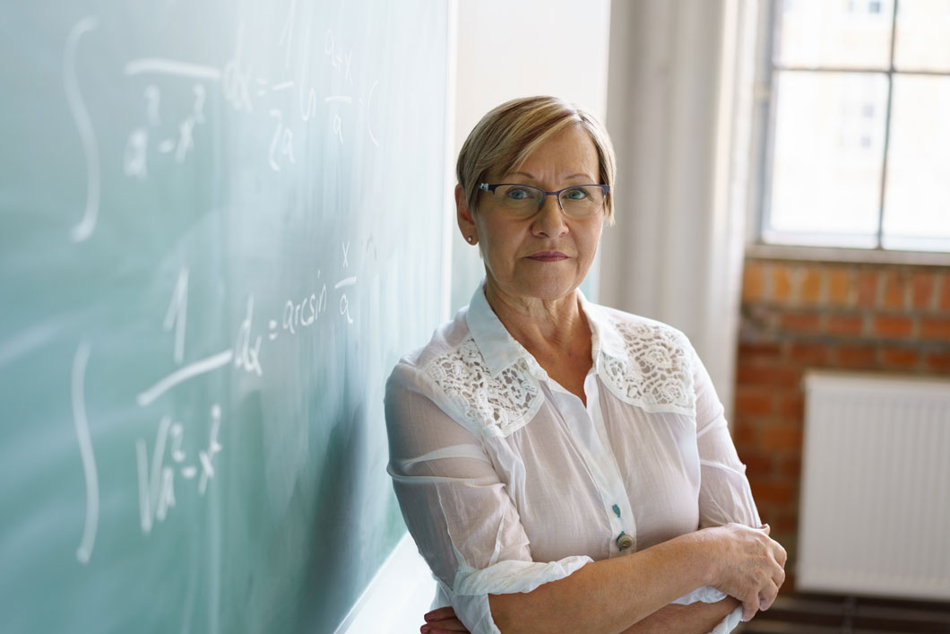 Teacher in front of chalkboard